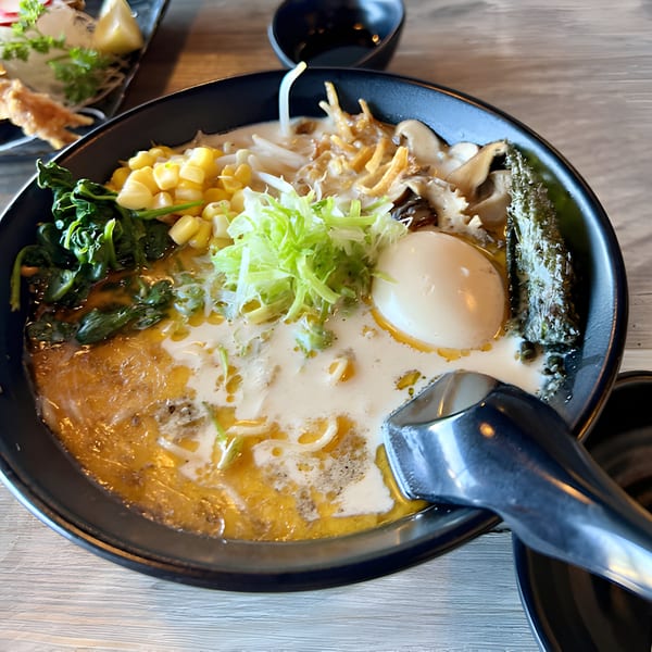 Slurpin' Ramen Bar's ramen bowl with corn, spinach, mushrooms, egg, and seaweed in rich broth.